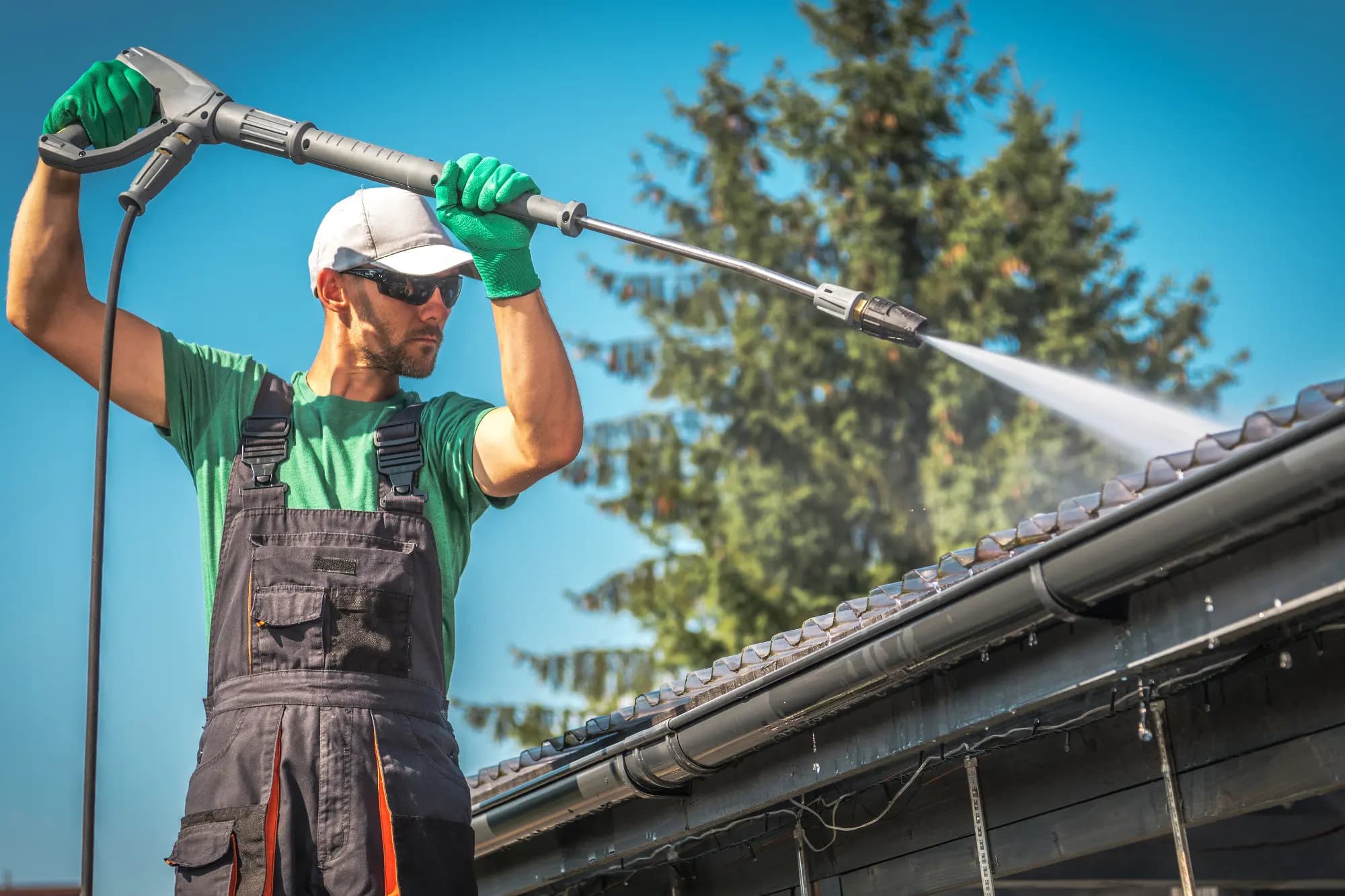A provider washing debris from residential gutters